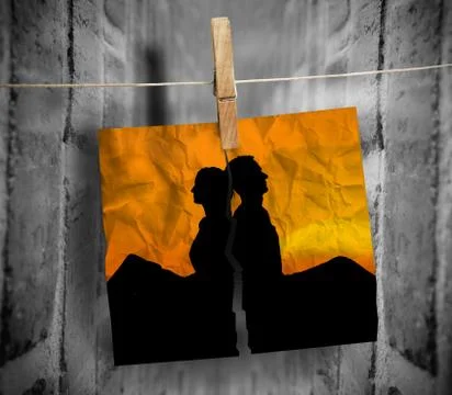 Torn photo of couple hung with a peg on a line Stock Photos