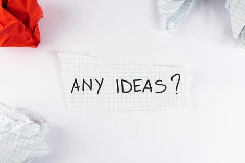 Torn piece of graph paper displaying the handwritten question any ideas sur.. Stock Photos
