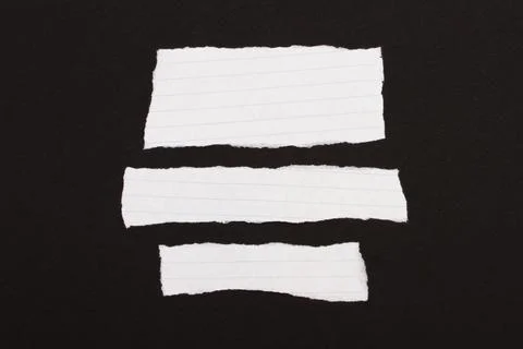 Torn pieces of paper in a checkered pattern. Stock Photos