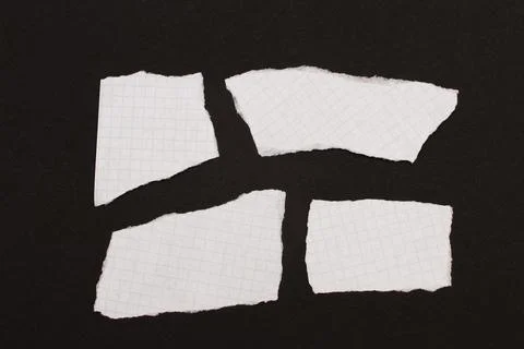Torn pieces of paper in a checkered pattern. Stock Photos