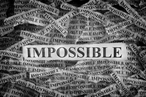 Torn pieces of paper with the words Impossible Stock Photos