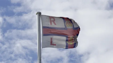 Torn rescue institution flag waving slow motion Stock Footage 338137335