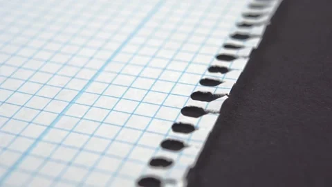 Torn school checkered blank note, notebook paper page on ripped black texture Stock Footage 172133394