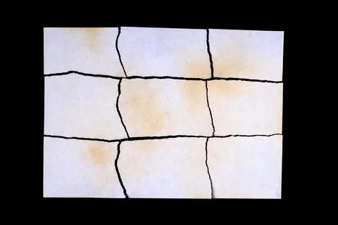 Torn sheet of yellowed old paper with multiple damage from fire and time, iso Stock Photos