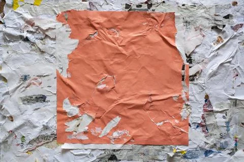 Torn square orange paper glued on dirty wall Stock Photos