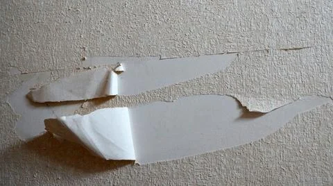 Torn wallpaper on the wall close up Stock Photos