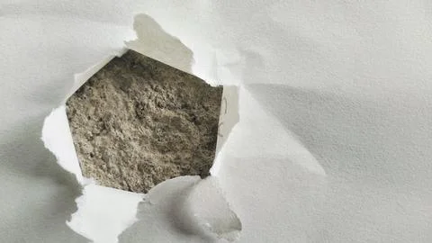 Torn White Paper Hole with Rough Gray Concrete Texture Background Stock Photos