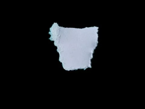 Torn White Paper Piece on Solid Black Background with Rough Edges Stock Photos