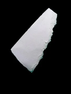 Torn White Paper Piece on Solid Black Background with Rough Edges 스톡 사진