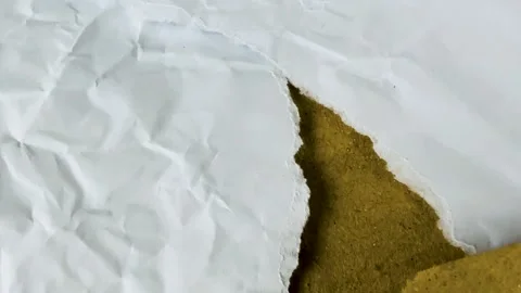 Torn white paper revealing brown cardboard texture underneath Stock Footage 340581381