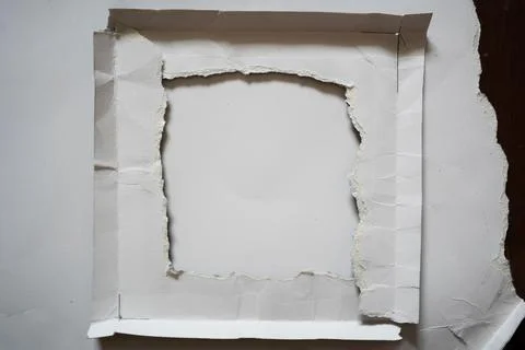 Torn white paper from a square frame shape Stock Photos