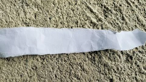 Torn White Paper Strip on Rough Gray Concrete Texture Background Stock Photos