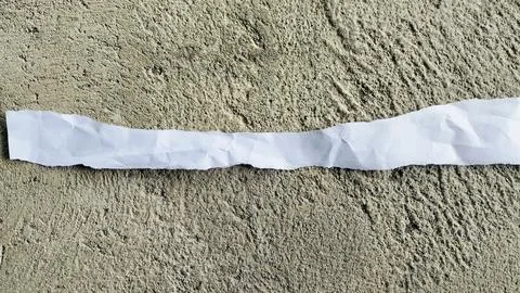 Torn White Paper Strip on Rough Gray Concrete Texture Background Stock Photos