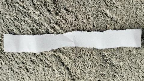 Torn White Paper Strip on Rough Gray Concrete Texture Background Stock Photos