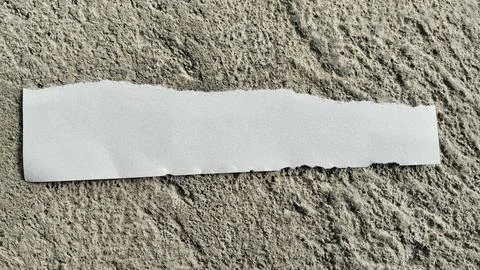 Torn White Paper Strip on Rough Gray Concrete Texture Background Stock Photos