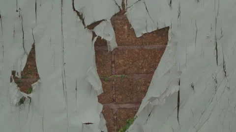 Torn White Wallpaper Peeling Off Old Red Brick Wall in Abandoned Building Stock Footage 330518063
