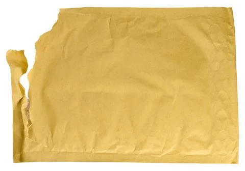 Torn yellow paper mailing envelope with bubble wrap on isolated background. Stock Photos
