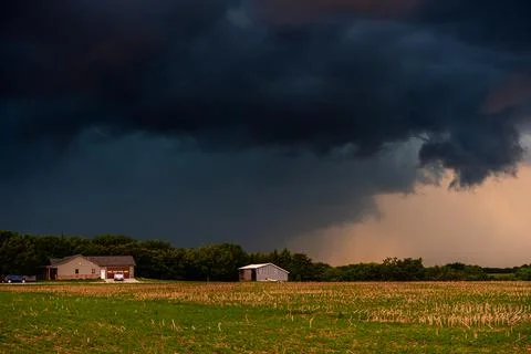 Tornadic storm clouds spin overhead in a dramatic sky, full of danger, shadow Stock Photos
