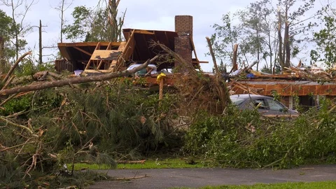 Tornado damage aftermath footage of a destroyed house and car. Stock Footage 128515643