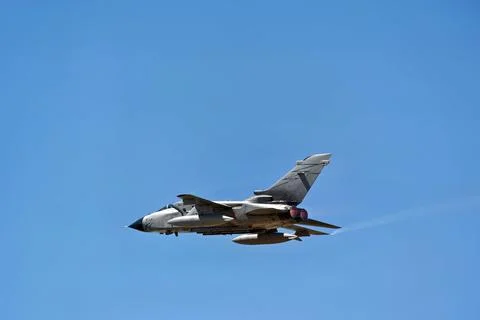 Tornado fighter jet with glowing engine nozzles against a blue sky Foto stock