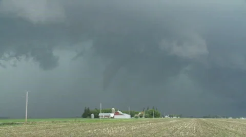 Tornado over farm buildings in Iowa Stock Footage