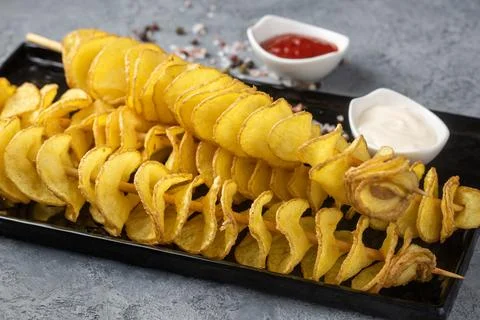 Tornado Potato, also known as Chips on a stick or Hoeori-gamja, refers to p.. Stock Photos