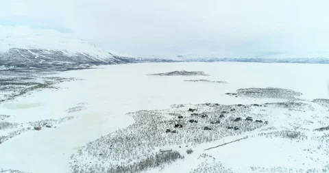 Tornetrask lake, C4k aerial, tracking, drone shot, of a village of huts on th Stock Footage 112270990
