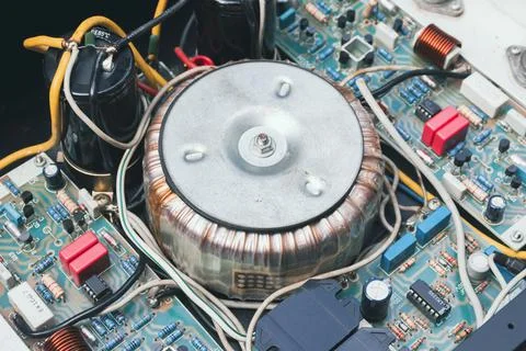 Toroidal transformer in electrical appliance Stock Photos