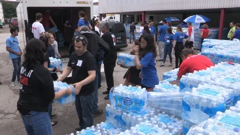 Toronto aid workers load plastic water bottles for the homeless during heatwave Stock Footage 91520111