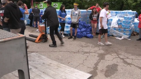 Toronto aid workers load plastic water bottles for the homeless during heatwave Stock Footage 91523644