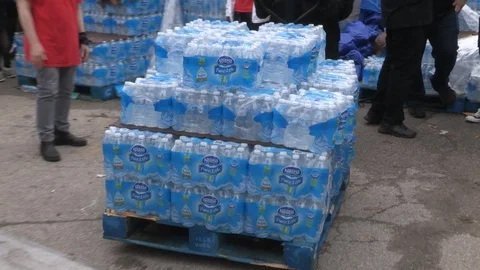 Toronto aid workers load plastic water bottles for the homeless during heatwave Stock Footage 91535306