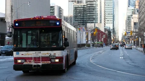 Toronto Bus drives towards camera with city skyscrapers Stock Footage 149218287