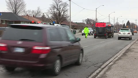 Toronto, Can,  May 5 2026 Workers fill potholes on city streets with asphalt Stock Footage 340910581