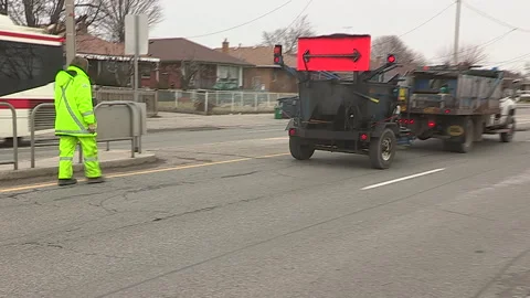Toronto, Can,  May 5 2026 Workers fill potholes on city streets with asphalt Stock Footage 340910590