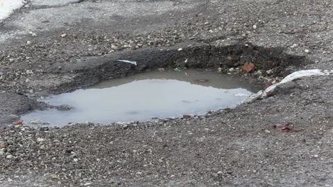 Toronto, Canada Aug 29 2026 Large Potholes on Street, Damaged Asphalt Stock Footage 345852447