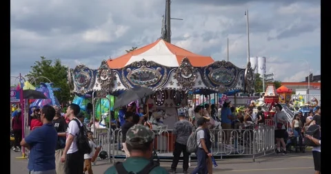 Toronto, Canada - August 29, 2026: Carousel ride surrounded by visitors at the Stock Footage 344091813
