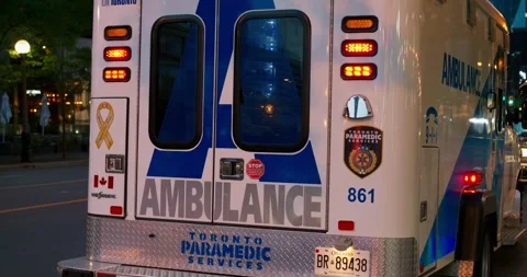 Toronto, Canada - May 6, 2023: Cinematic shot of back of ambulance in Canada Video stock 245618997