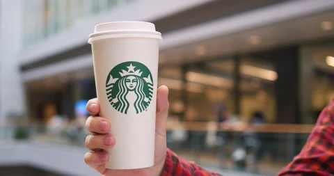 Toronto, Canada - May 6, 2023: video features hand holding Starbucks coffee cup Stock Footage 278307504