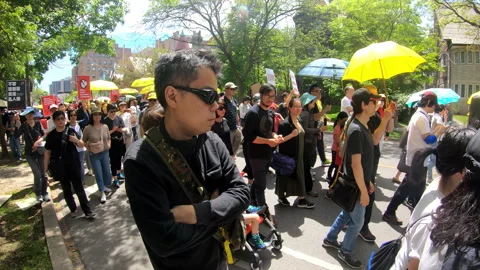 Toronto, Canada Oct 12 2014 Yellow Umbrella March for Hong Kong freedom Stock Footage 345757342
