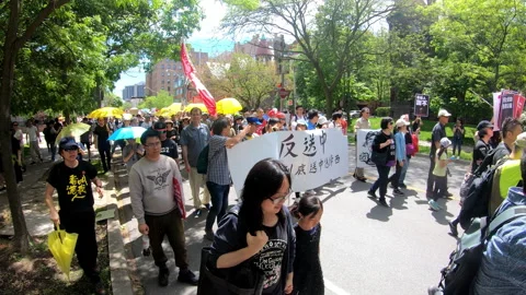 Toronto, Canada Oct 12 2014 Yellow Umbrella March for Hong Kong freedom Stock Footage 345757346