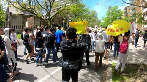 Toronto, Canada Oct 12 2014 Yellow Umbrella March for Hong Kong freedom Stock Footage 345757487