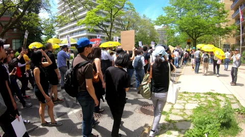 Toronto, Canada Oct 12 2014 Yellow Umbrella March for Hong Kong freedom Stock Footage 345757669