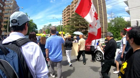 Toronto, Canada Oct 12 2014 Yellow Umbrella March for Hong Kong freedom Stock Footage 345757914