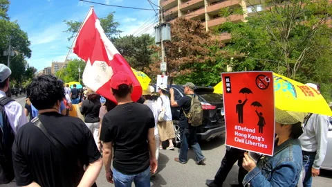 Toronto, Canada Oct 12 2014 Yellow Umbrella March for Hong Kong freedom Stock Footage 345758178