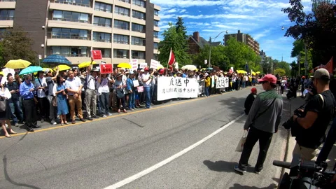 Toronto, Canada Oct 12 2014 Yellow Umbrella March for Hong Kong freedom Stock Footage 345758679