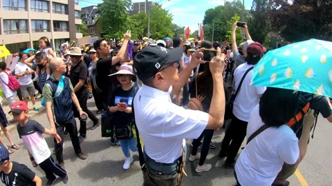 Toronto, Canada Oct 12 2014 Yellow Umbrella March for Hong Kong freedom Stock Footage 345758890