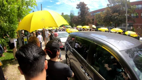 Toronto, Canada Oct 12 2014 Yellow Umbrella March for Hong Kong freedom Stock Footage 345759360