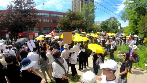 Toronto, Canada Oct 12 2014 Yellow Umbrella March for Hong Kong freedom Stock Footage 345759992