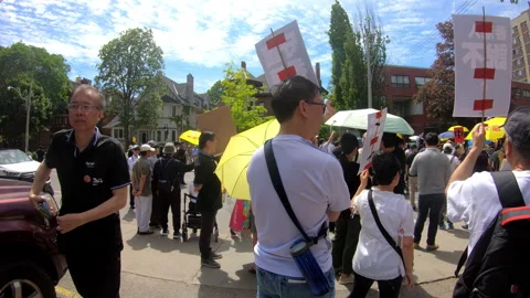 Toronto, Canada Oct 12 2014 Yellow Umbrella March for Hong Kong freedom Stock Footage 345760090