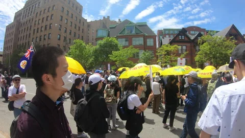 Toronto, Canada Oct 12 2014 Yellow Umbrella March for Hong Kong freedom Stock Footage 345761292